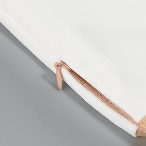 Close-up of seamless invisible zipper and fine stitching on white mesh midi dress