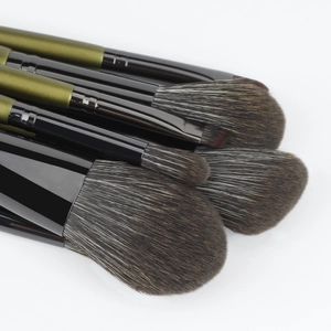 Professional 9-piece makeup brush set with green metallic handles and soft bristles