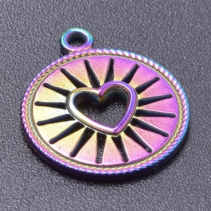 Macro shot of a rainbow-plated stainless steel circular pendant with heart cutout and rope edge