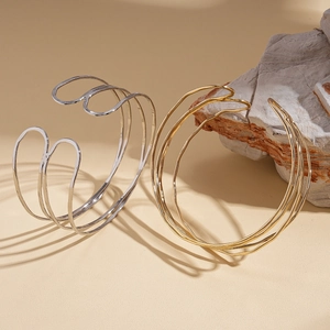 Minimalist multi-layer geometric open cuff bracelet in polished gold and silver metal finishes