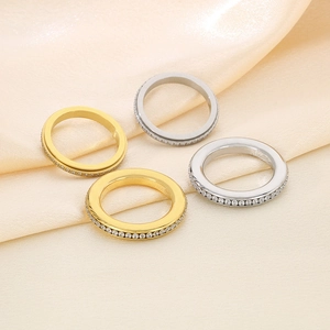 Macro shot of gold and silver eternity rings with cubic zirconia on champagne silk