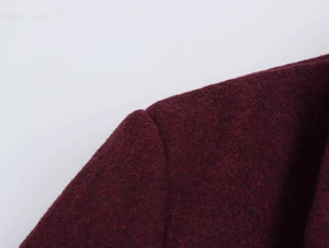 Macro view of shoulder seam stitching on this burgundy wool blend blazer for women