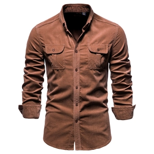 Detailed macro view of vintage brown corduroy shirt texture and dual chest pockets