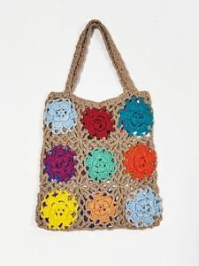 Detailed close-up of handmade crochet tote bag featuring vibrant granny square floral patterns