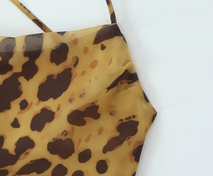 Detail of leopard print dress showing yellow chiffon fabric and fine spaghetti straps