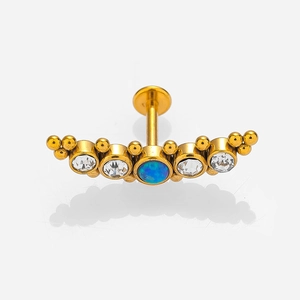 Macro view of gold 316L stainless steel labret with blue opal and white zircon stones