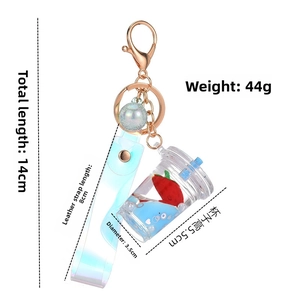 Detail of strawberry milk tea cup keychain with dimensions and liquid floating effect