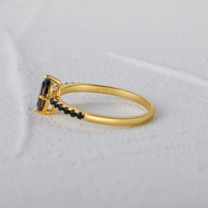 Macro detail of S925 sterling silver gold ring featuring a large black gemstone inlay