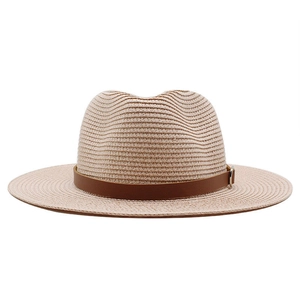 Close-up of a beige straw Panama hat featuring a brown leather band and silver buckle