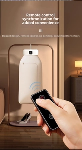 Close-up of a white portable clothes dryer showing the wireless remote control and LED display