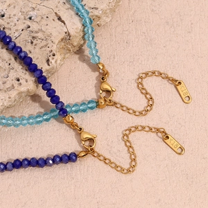 Detail of blue crystal beaded necklace with K18 gold lobster clasp and extension chain