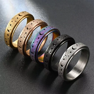 Macro shot of rotating stainless steel rings with moon and star patterns in five colors