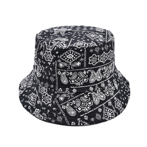 Detailed close-up of stitching on black paisley cotton bucket hat with flat top design