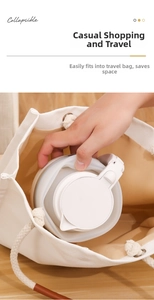Collapsible silicone kettle being placed into a canvas bag to show portable size