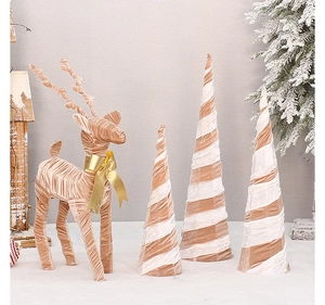 Pink velvet reindeer statue with ribbon bow and spiral cone trees for Christmas decor