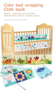 Detail of double-sided baby cloth book with built-in BB squeaker and ties for crib rail