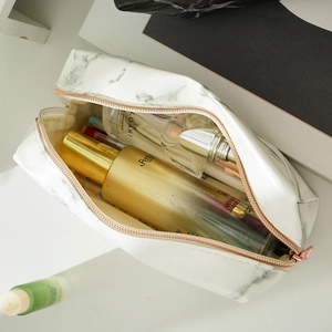 Top view of large capacity white marble PU makeup bag with rose gold zipper open interior