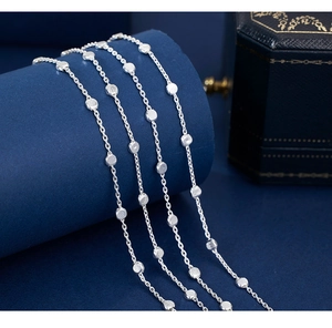 Detail of minimalist 925 sterling silver chain necklaces with textured round metal beads