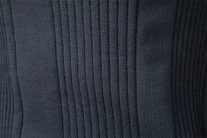 Detailed macro shot of dark blue ribbed knit fabric texture on a premium men's sweater