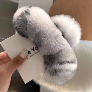 Close-up of oversized fluffy faux fur hair claw clip in grey and white soft textures