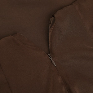 Macro view of a dark brown dress featuring a smooth hidden zipper and woven texture
