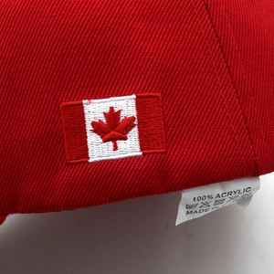 Detailed view of red maple leaf embroidery on 100% acrylic Canadian baseball cap