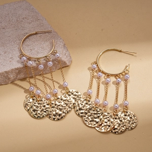 Bohemian gold tassel earrings with faux pearls and hammered metal discs on grey stone