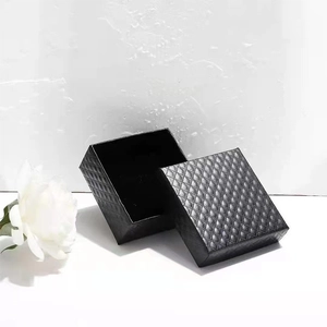 Elegant black jewelry box with quilted texture and camellia decoration for rings