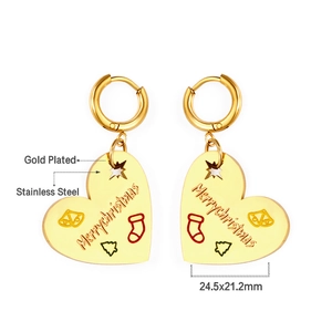 Detailed close-up of gold plated stainless steel heart earrings with Christmas engraving