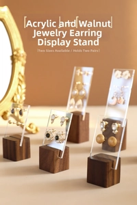 Macro view of walnut wood and acrylic earring stands showing dual-pair capacity