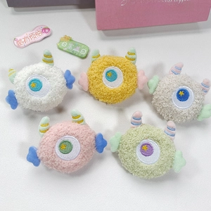 Cute plush monster brooch charms with colorful horns and single eye detail in five soft colors