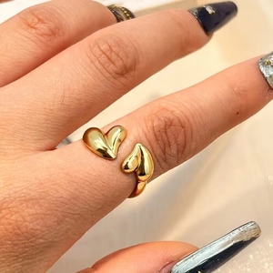 Adjustable golden stainless steel open ring featuring dual polished heart motifs