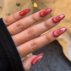 Glossy red cherry press-on nails with almond shape and golden leaf 3D decoration