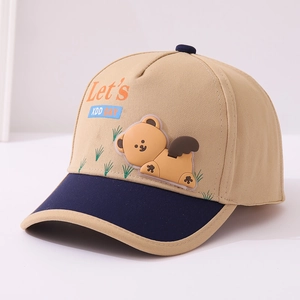 Detail of cartoon bear patch and embroidery on khaki and navy kids baseball cap