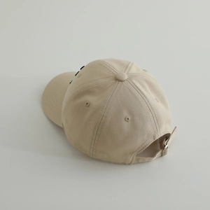 Detail of adjustable metal buckle and stitching on children baseball cap