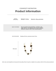 Detail view of layered gold necklace with black oval gemstone pendants and sizing data