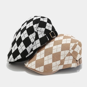 Close-up of diamond pattern texture and metal side buckle on British style beret hats
