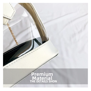 Detailed macro view of white lychee grain leather trim and golden metal chain on PVC bag