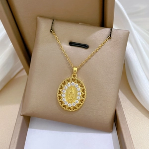 Macro shot of oval Virgin Mary pendant with white zircons and heart cutout edges