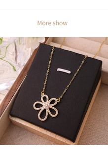 Detailed view of an 18K gold floral pendant necklace featuring sparkling zircon petals