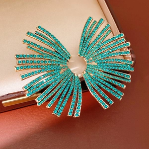 Macro shot of fan-shaped earrings with turquoise crystals in a luxury jewelry box