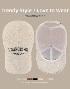 Detailed view of beige faux shearling baseball cap with vintage embroidery and interior lining