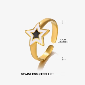 Macro shot of gold adjustable stainless steel ring with black and white star pattern
