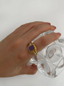 Detail of a vintage 18k gold plated ring featuring purple enamel and side zircons