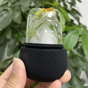 Detail of a silicone ice face roller with frozen yellow flowers for facial massage treatment