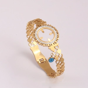 Detail of gold heart hollow chain bracelet featuring blue evil eye charm and crystal accents