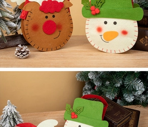 Close-up of felt Christmas gift bags with reindeer and snowman cartoon designs