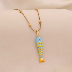 Detailed view of a gold chain with a colorful blue and yellow enamel fish pendant