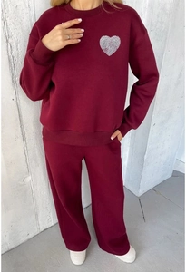 Detail view of burgundy sweatshirt and jogger set with white heart print on the chest