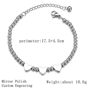 Polished silver stainless steel ball bracelet featuring three heart charms and extension chain